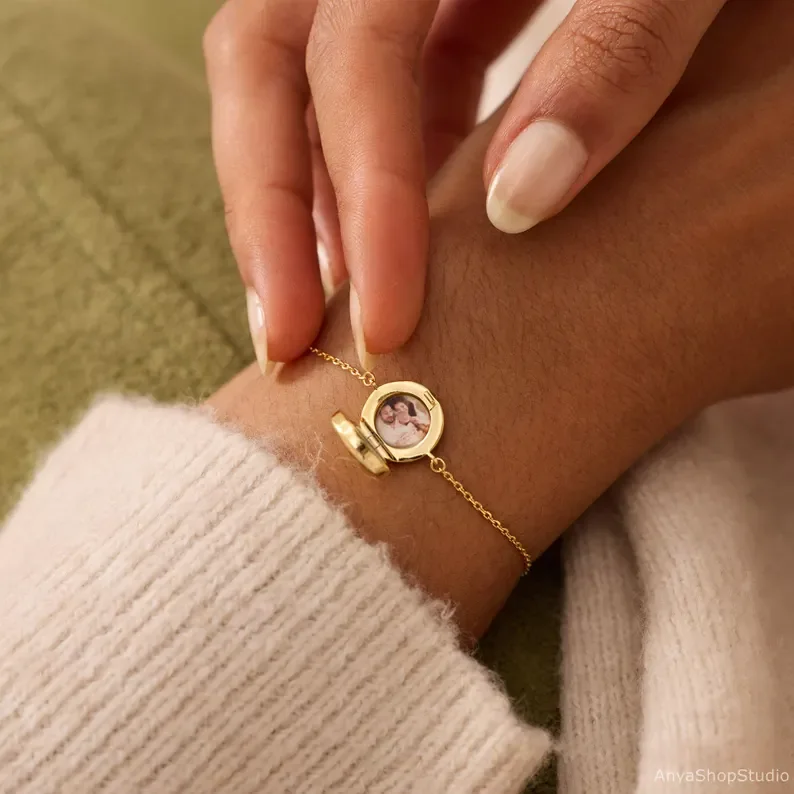 Gold locket bracelet open with a family photo inside